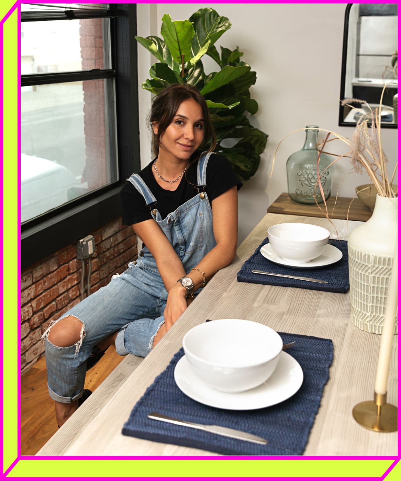 Lily Montasser sitting at her dining table with her new The Home Depot dinnerware.