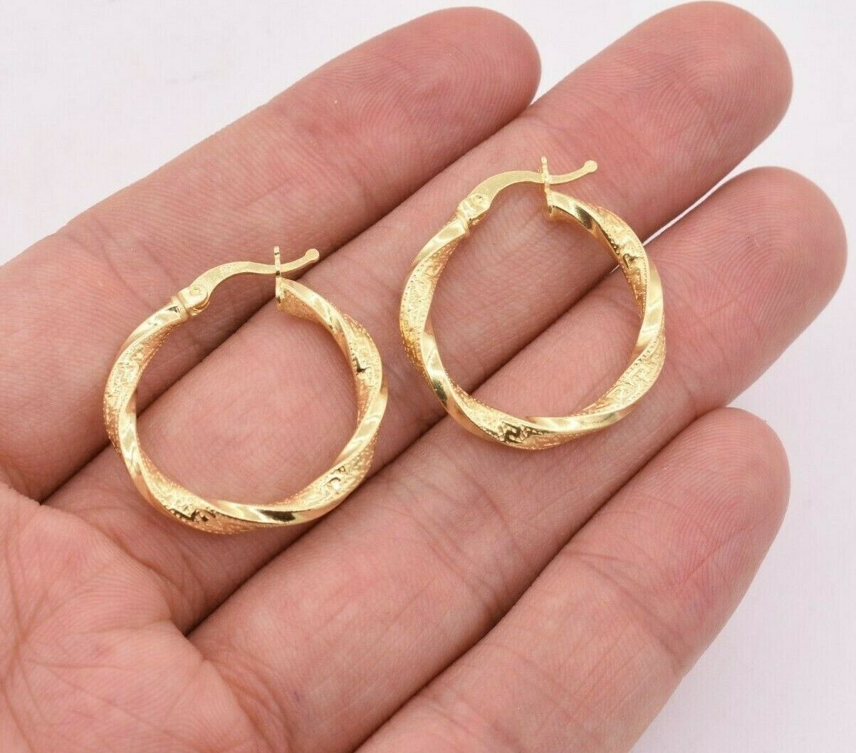 twisted hoop earrings in 14k gold and white vermeil